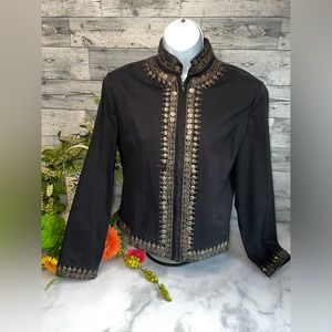 Black studded jean jacket. Size m Missing a jewel at neck and bottom front.
